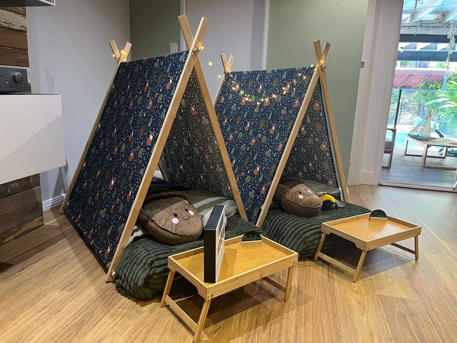 A styled two-teepee camp in a lounge room